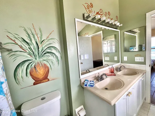 a bathroom with a double vanity sink mirror and shower