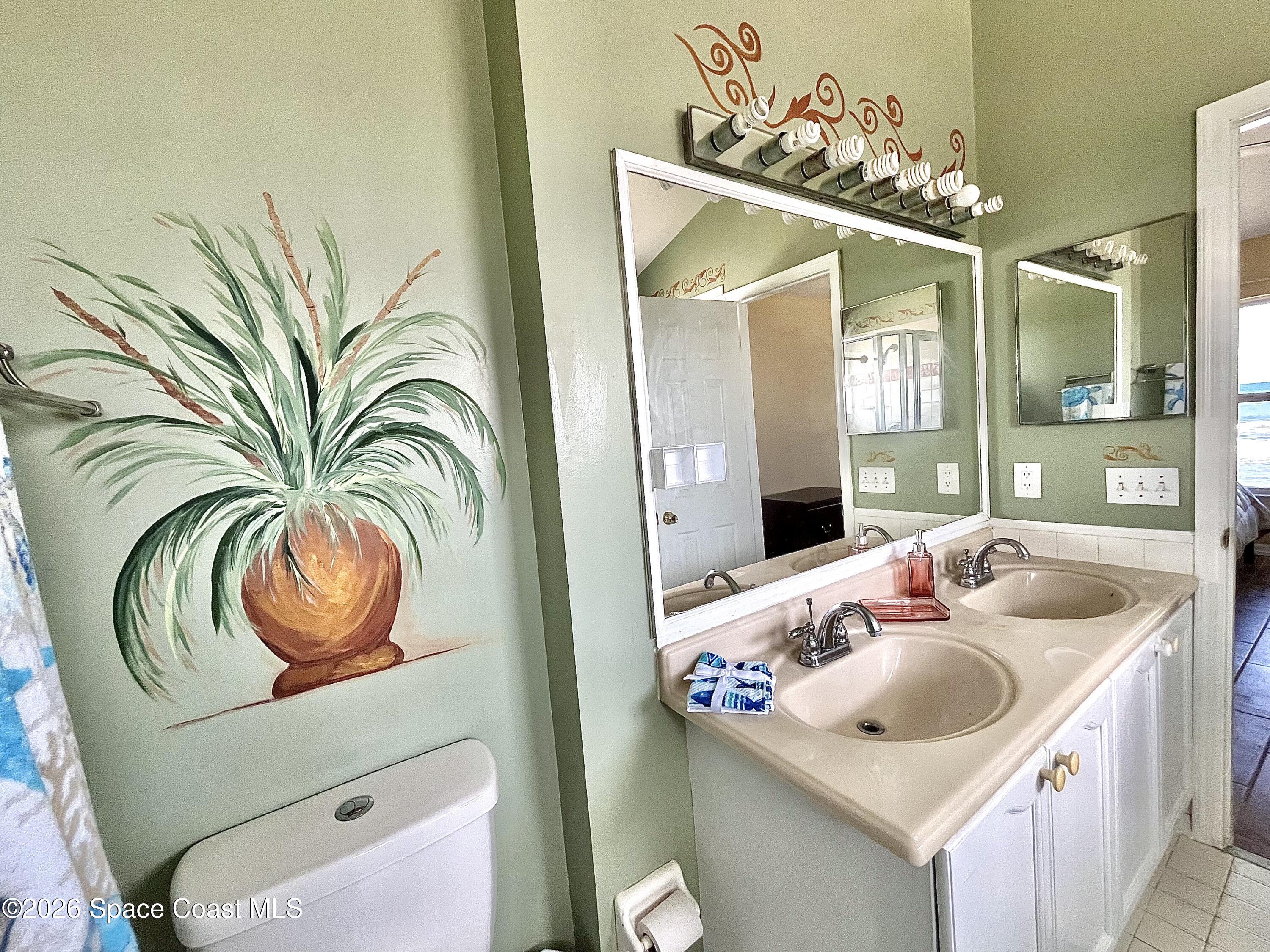 799 Shell Street Satellite Beach, FL 32937 - Photo 24 of 32 a bathroom with a sink a mirror and vanity