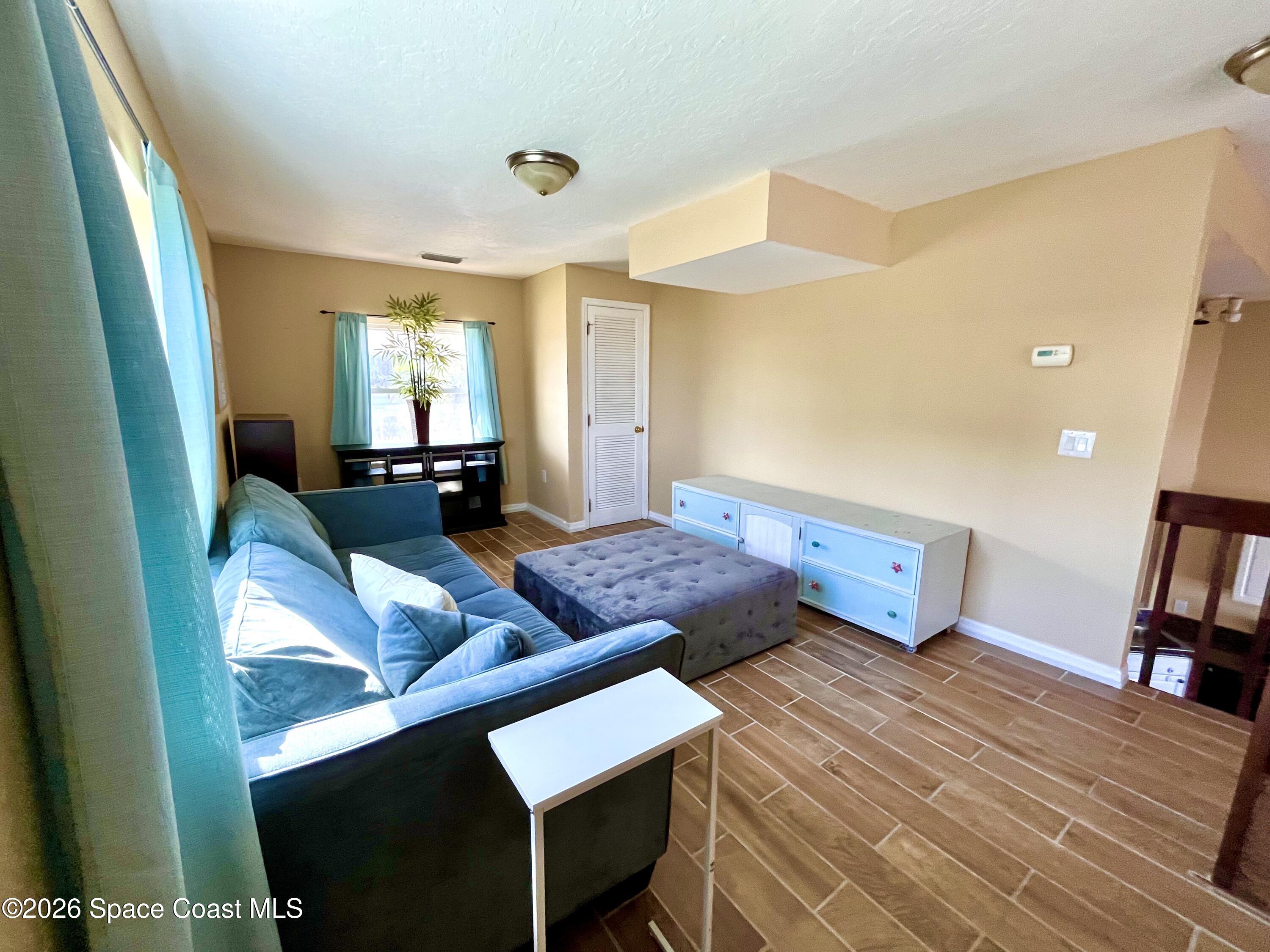 799 Shell Street Satellite Beach, FL 32937 - Photo 6 of 32 a bedroom with a bed and wooden floor