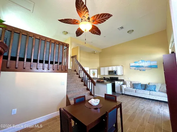 a view of a dining room with furniture and wooden floor