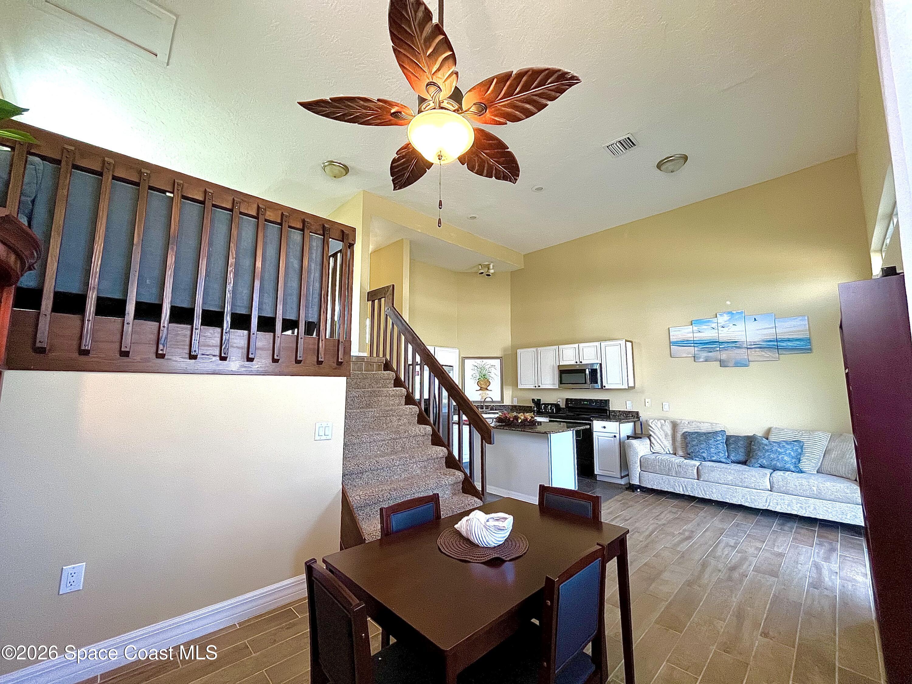 799 Shell Street Satellite Beach, FL 32937 - Photo 8 of 32 a view of a dining room with furniture and wooden floor