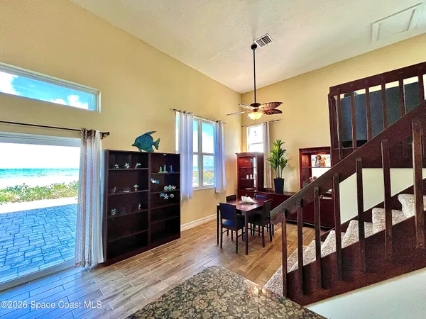 a view of a livingroom with furniture and staircase