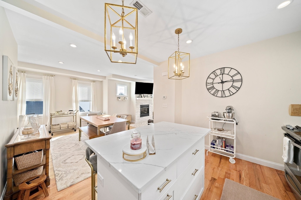 11 Mason Street, Unit 2 Everett, MA 02149 - Photo 11 of 28 a view of a dining room with furniture a chandelier and wooden floor