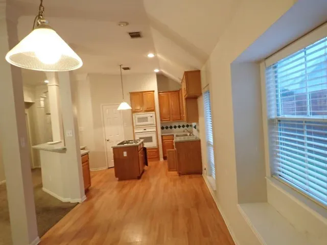 a stove top oven sitting inside of a kitchen