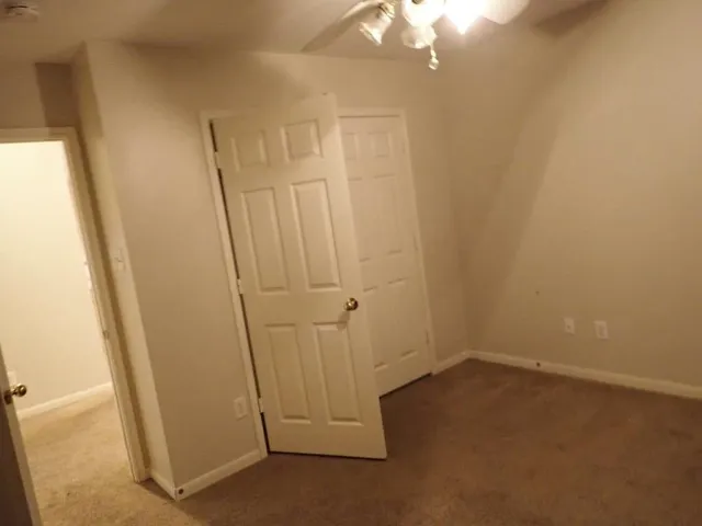 a white toilet sitting next to a bath tub