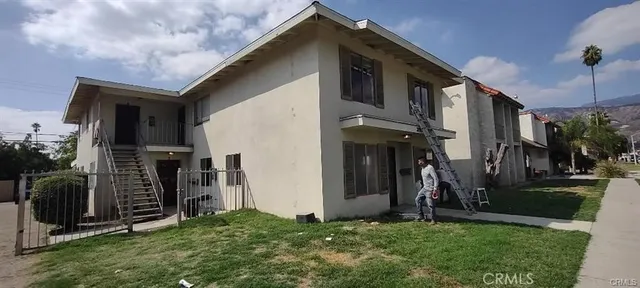 a view of a house with many windows and a yard