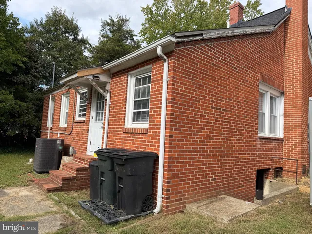 a view of a house with a yard and furniture