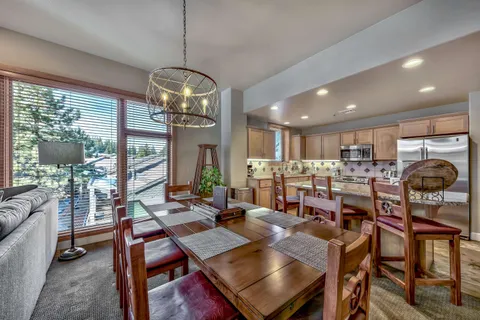 a view of a dining room with furniture wooden floor and chandelier