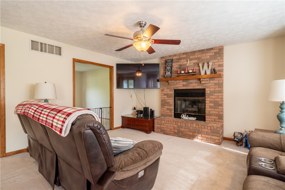 3628 Petre Road Springfield, OH 45502 - Photo 5 of 52 This inviting living area features a cozy fireplace, creating a warm and welcoming atmosphere.