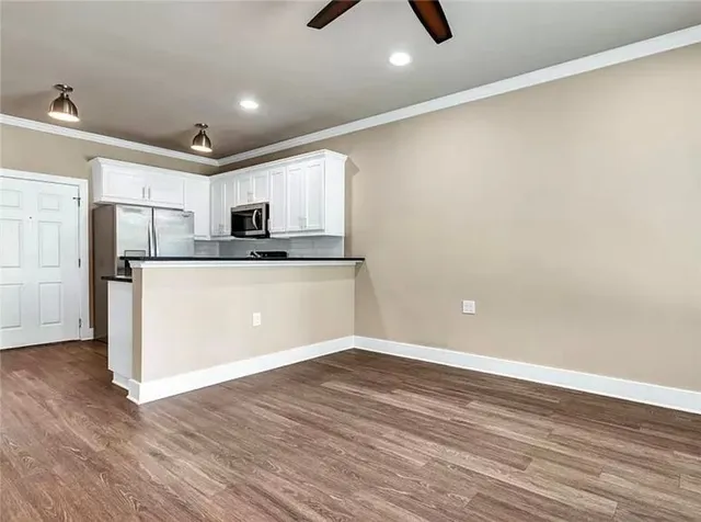 a view of a kitchen with microwave and cabinets