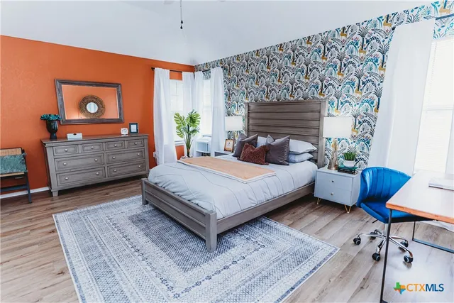 a bed room with a bed and a chair