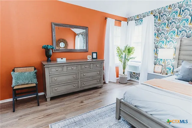 a bedroom with a bed and a dresser