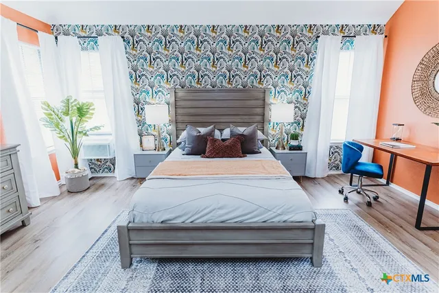 a bedroom with a bed chair and a window