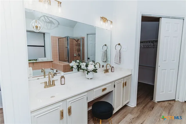 a bathroom with a sink double vanity and a mirror