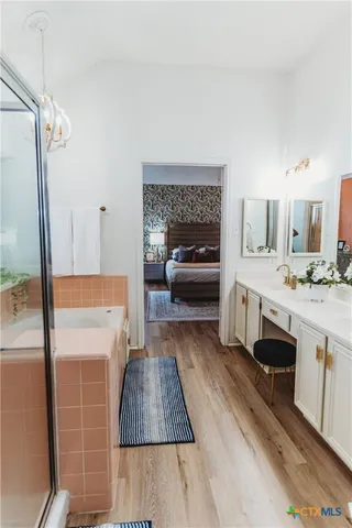 a en suite bathroom with a sink and a mirror