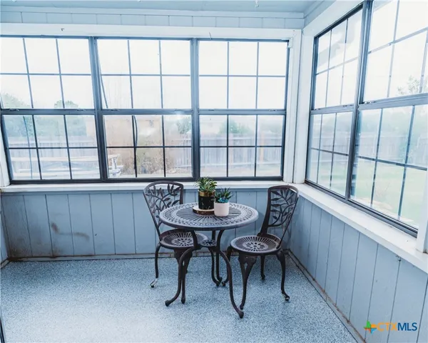 a view of a room with furniture and window