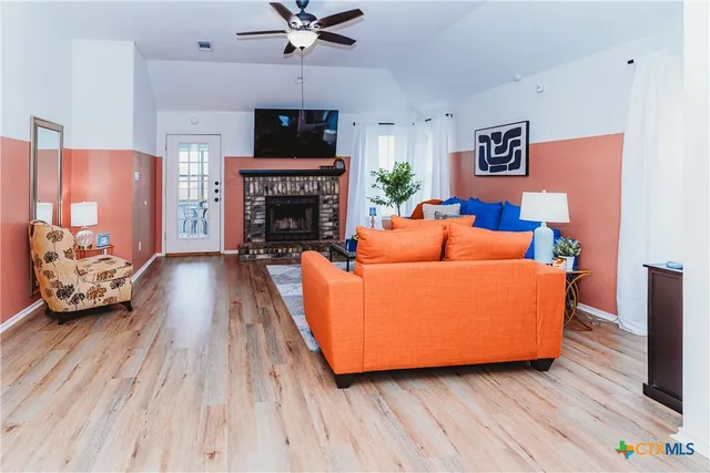 a living room with furniture and a fireplace