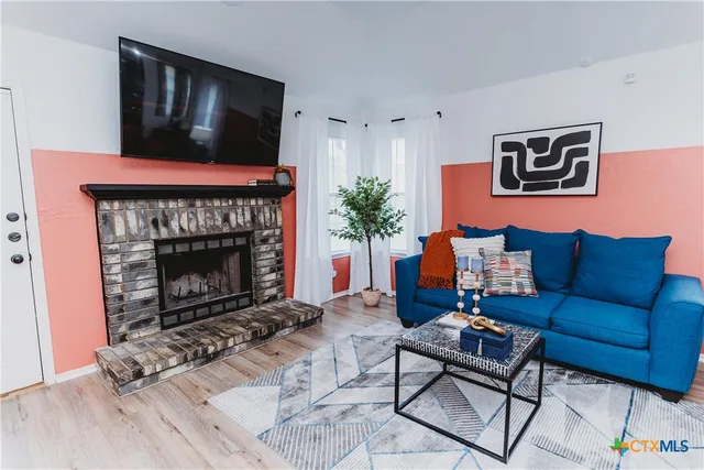 a living room with furniture and a fireplace