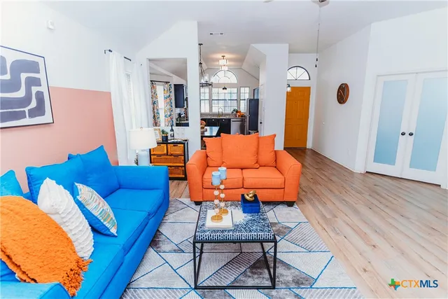 a living room with furniture and a chandelier