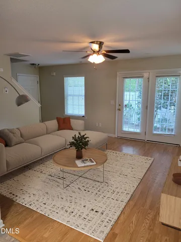 a living room with a couch and chandelier