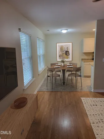 a view of a dining room with furniture and wooden floor
