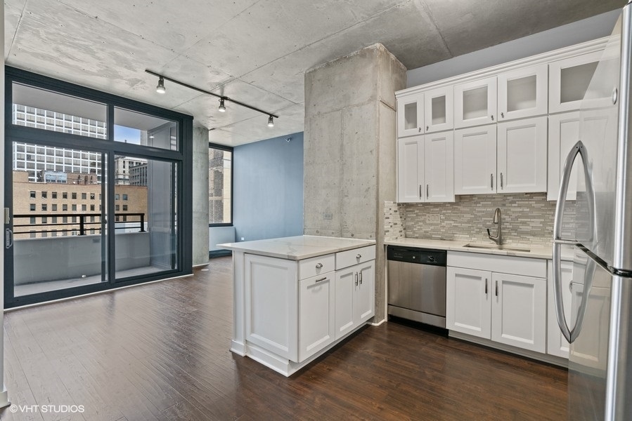 235 West Van Buren Street, Unit 1622 Chicago, IL 60607 - Photo 11 of 29 a kitchen with stainless steel appliances granite countertop a stove and a white cabinets
