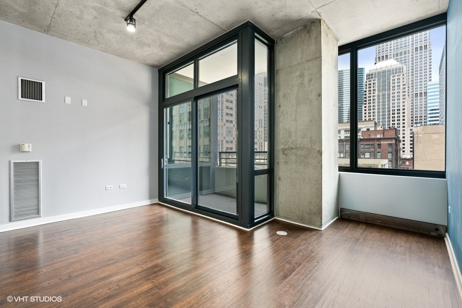 235 West Van Buren Street, Unit 1622 Chicago, IL 60607 - Photo 12 of 29 a view of an empty room with glass door