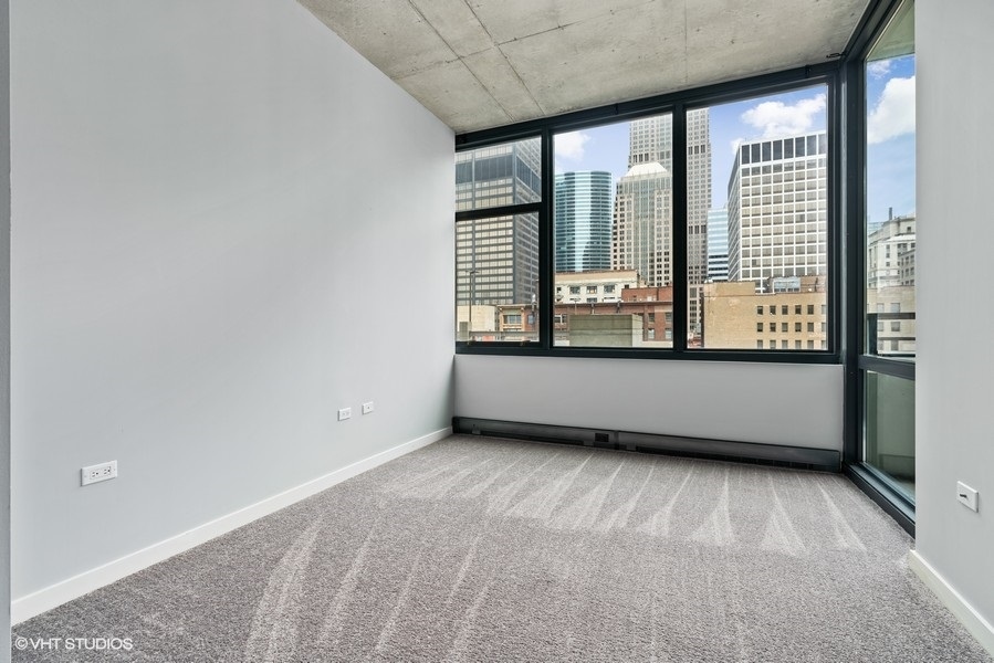 235 West Van Buren Street, Unit 1622 Chicago, IL 60607 - Photo 14 of 29 a view of an empty room with a window
