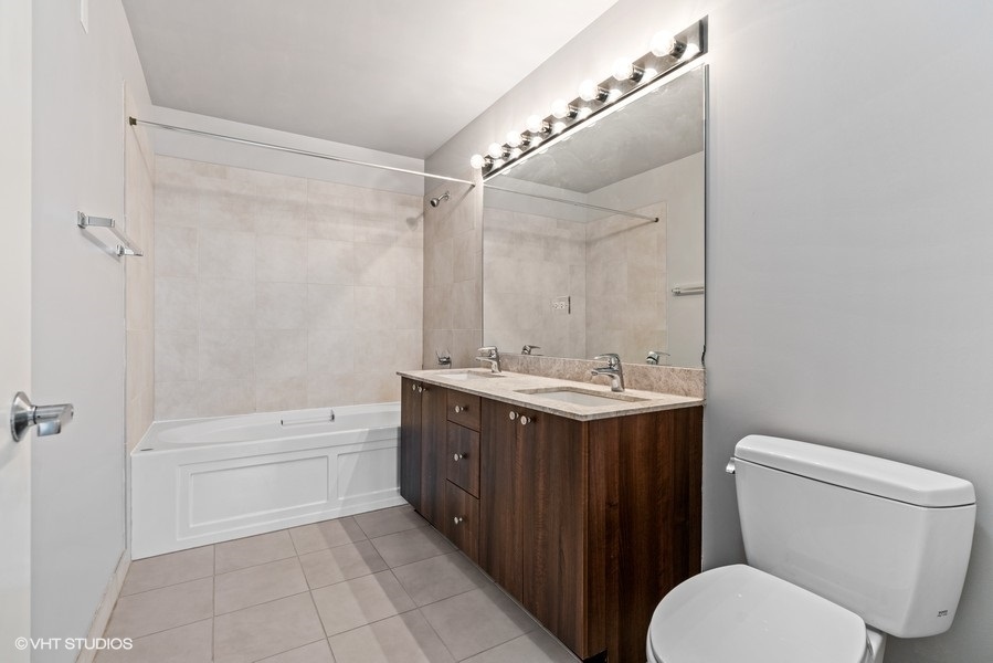 235 West Van Buren Street, Unit 1622 Chicago, IL 60607 - Photo 16 of 29 a bathroom with a sink toilet and shower