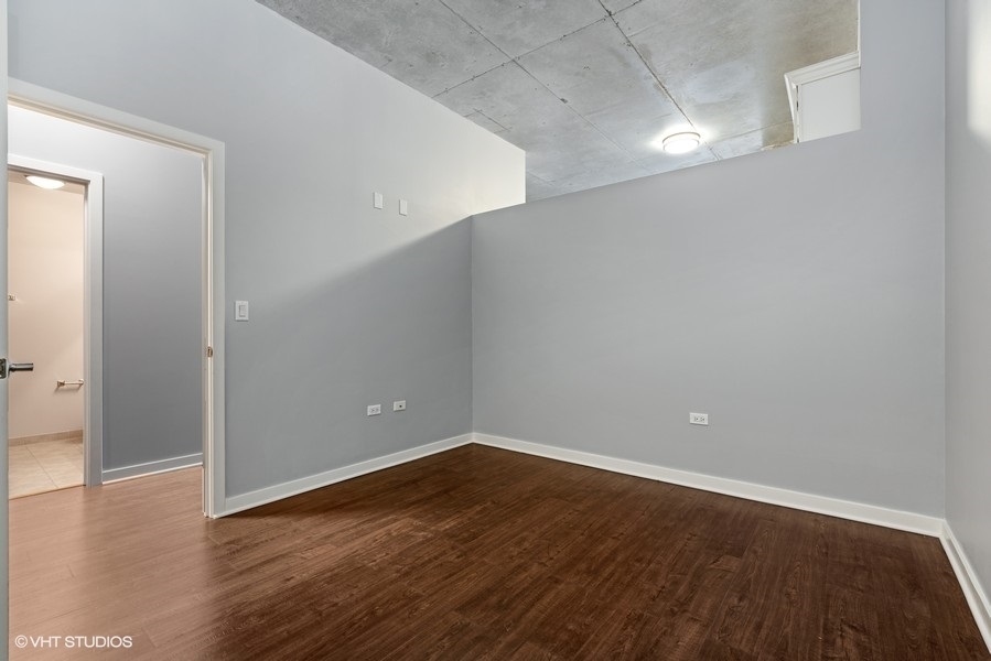 235 West Van Buren Street, Unit 1622 Chicago, IL 60607 - Photo 17 of 29 a view of an empty room with wooden floor