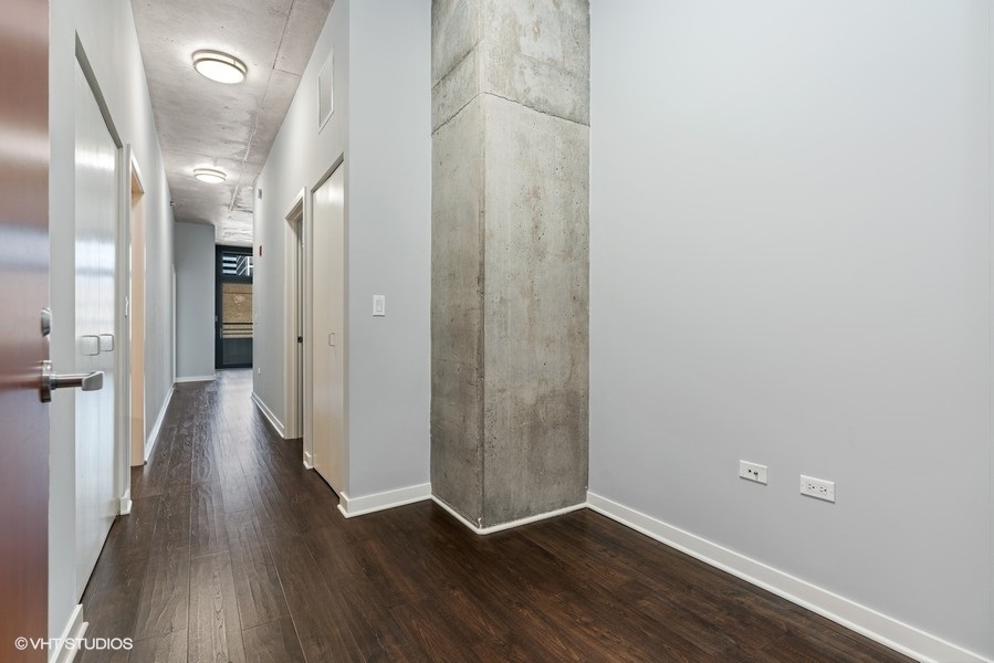 235 West Van Buren Street, Unit 1622 Chicago, IL 60607 - Photo 10 of 29 a view of a hallway with wooden floor
