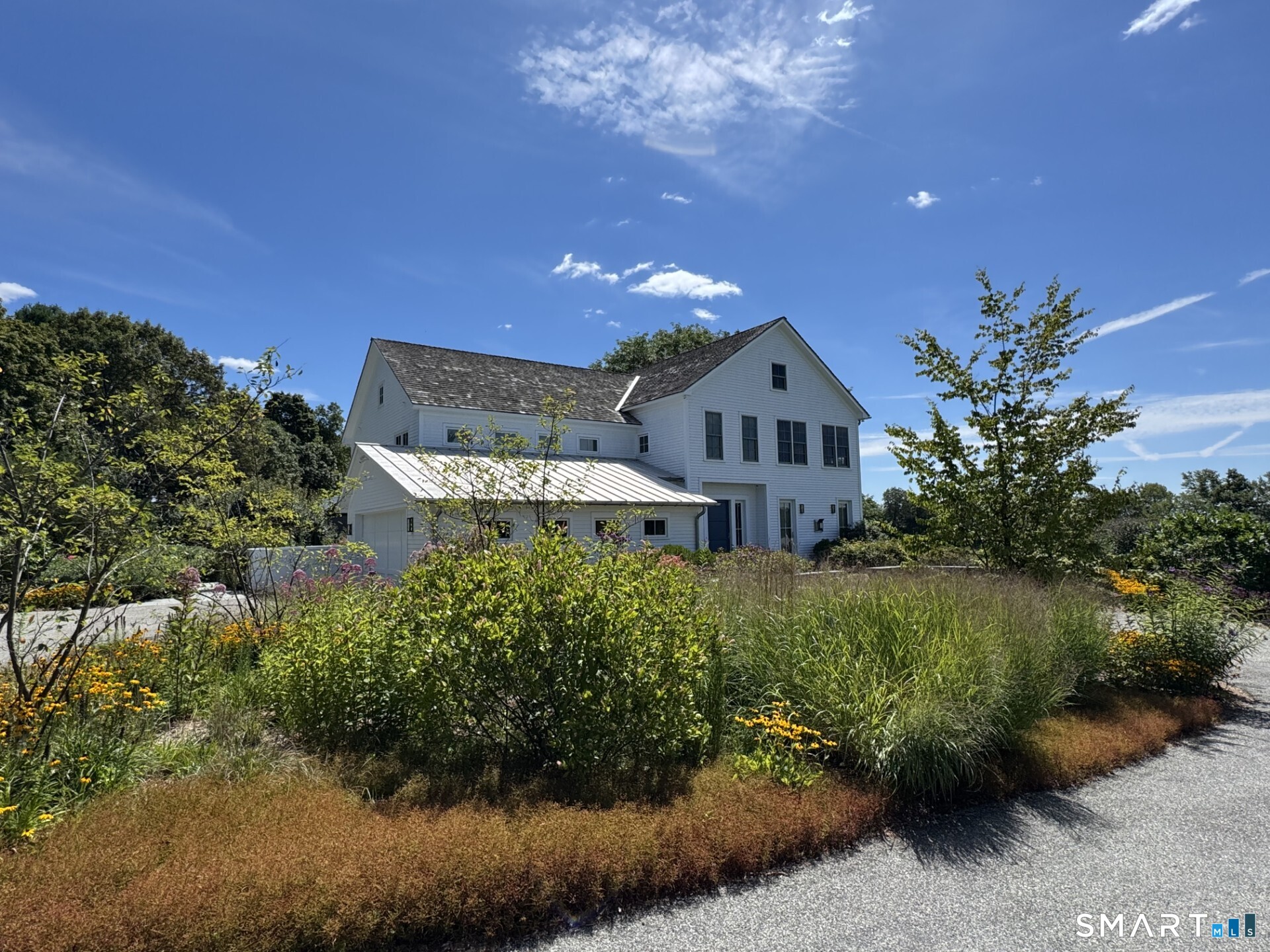 79 East Street Washington, CT 06793 - Photo 2 of 40 a front view of a house with a yard