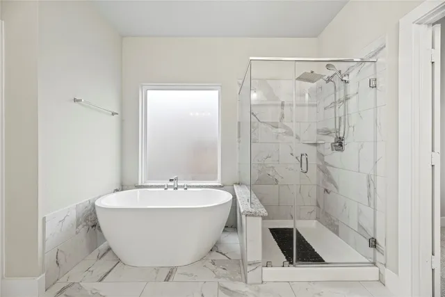 a bathroom with a bathtub and shower