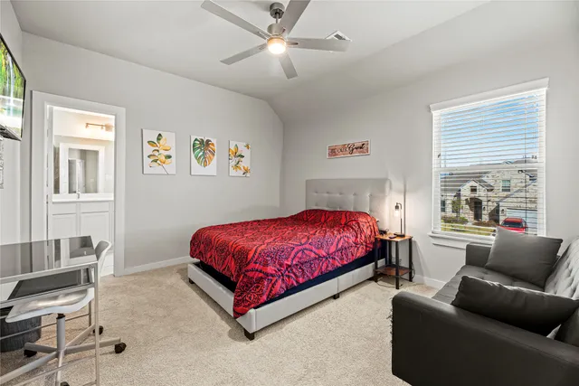 a bedroom with a bed couch and window