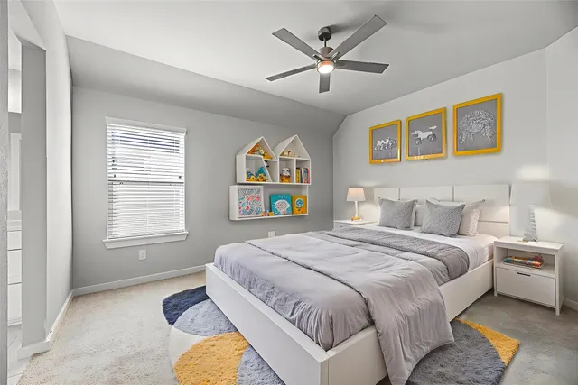 a spacious bedroom with a bed and a chandelier