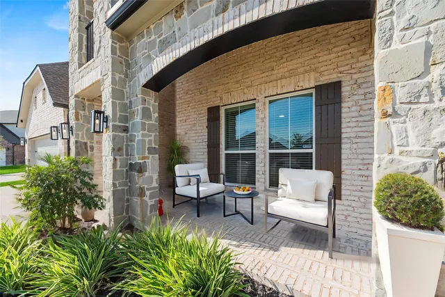a view of a patio with couches table and chairs and potted plants