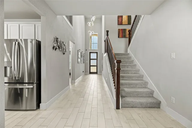 a view of entryway with wooden floor and stairs