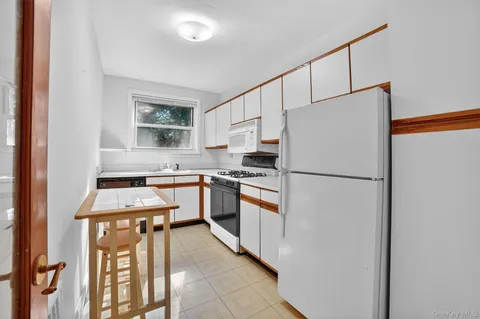 a kitchen with stainless steel appliances a refrigerator sink and cabinets