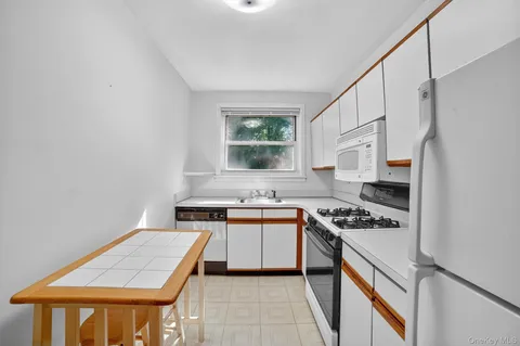 a kitchen with stainless steel appliances a stove a sink and a refrigerator