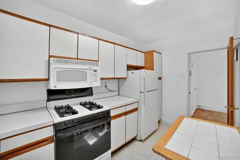 a kitchen with a refrigerator a stove a sink and a cabinets