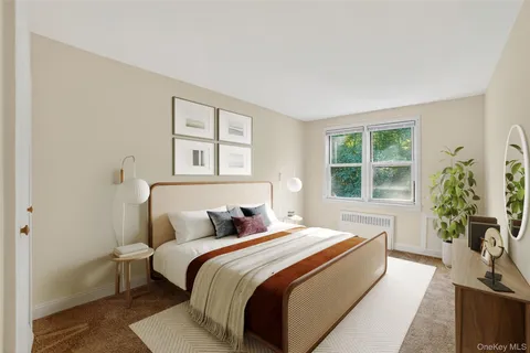 a bedroom with a large bed and a potted plant