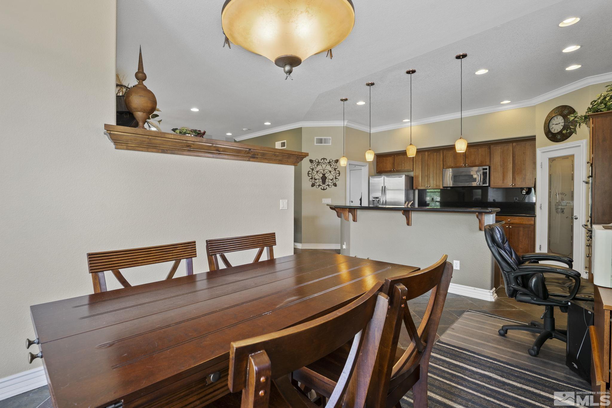 10080 Goler Wash Court Reno, NV 89521 - Photo 16 of 40 a view of a dining room with furniture and a chandelier