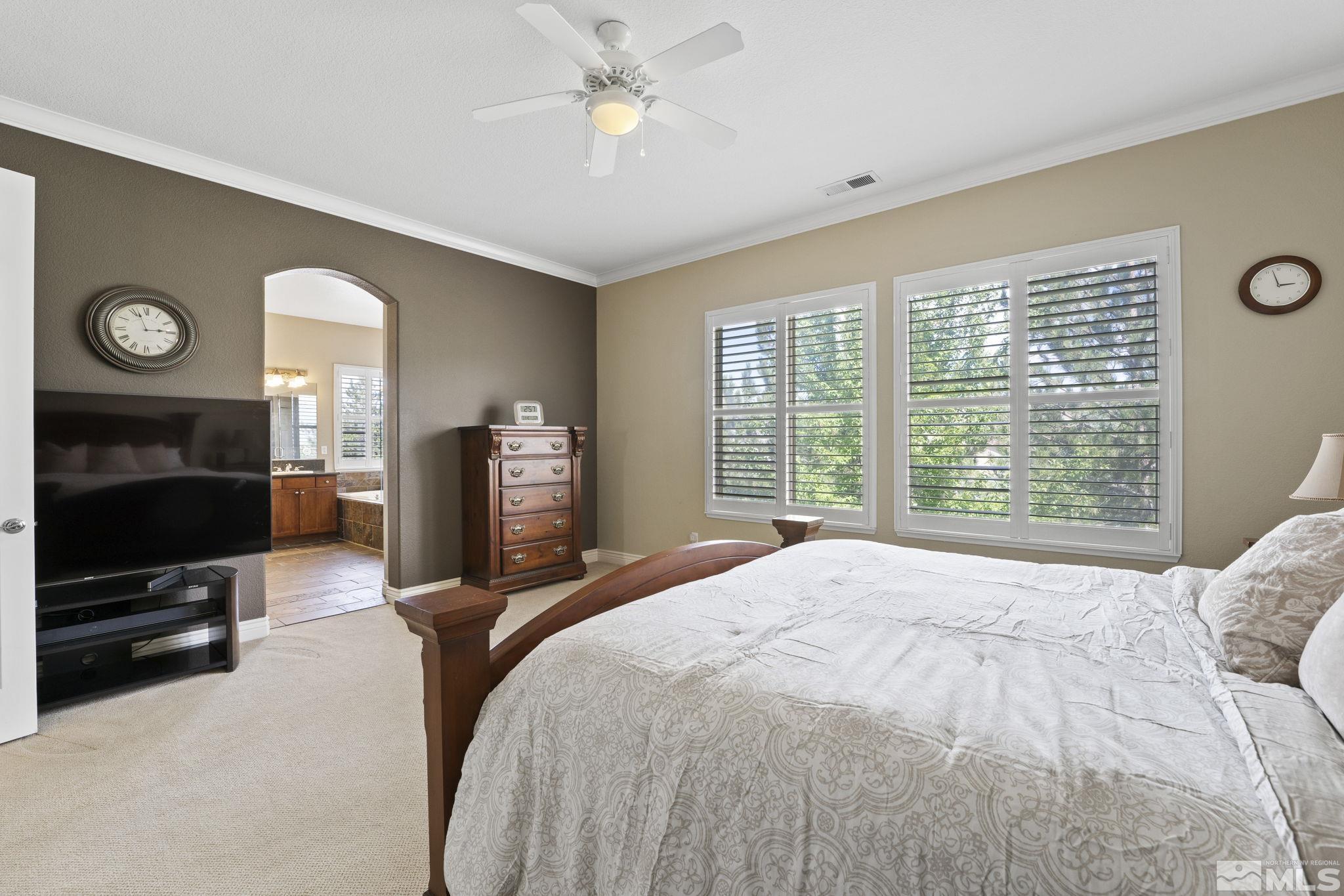 10080 Goler Wash Court Reno, NV 89521 - Photo 19 of 40 a spacious bedroom with a bed a dresser and a flat tv screen