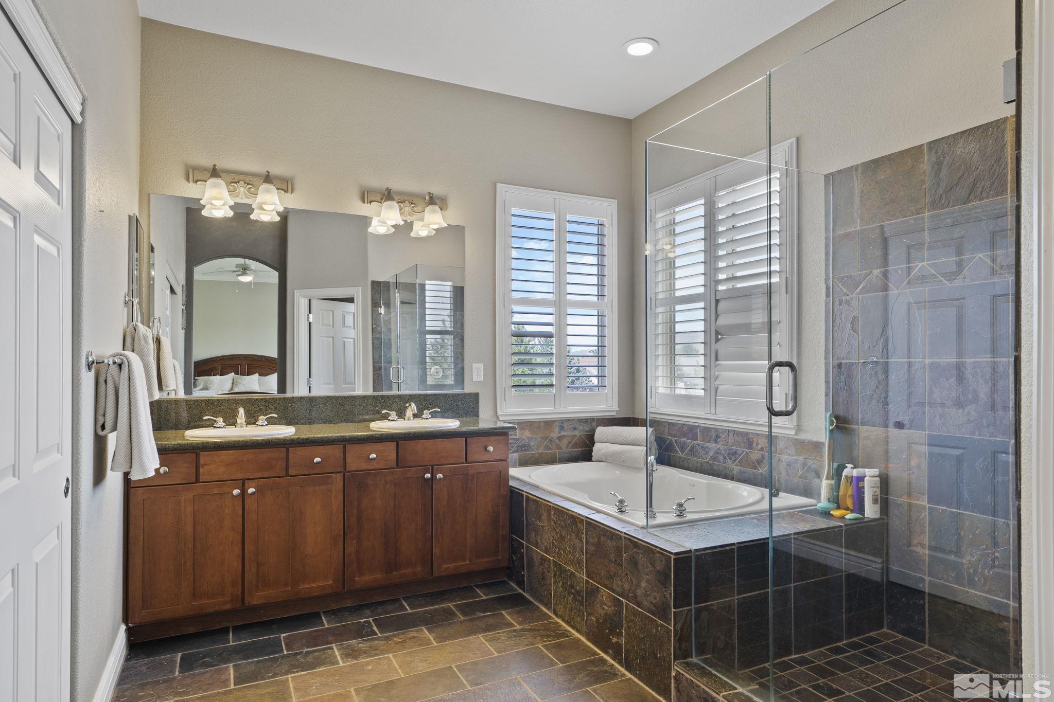 10080 Goler Wash Court Reno, NV 89521 - Photo 21 of 40 a bathroom with a tub sink and mirror
