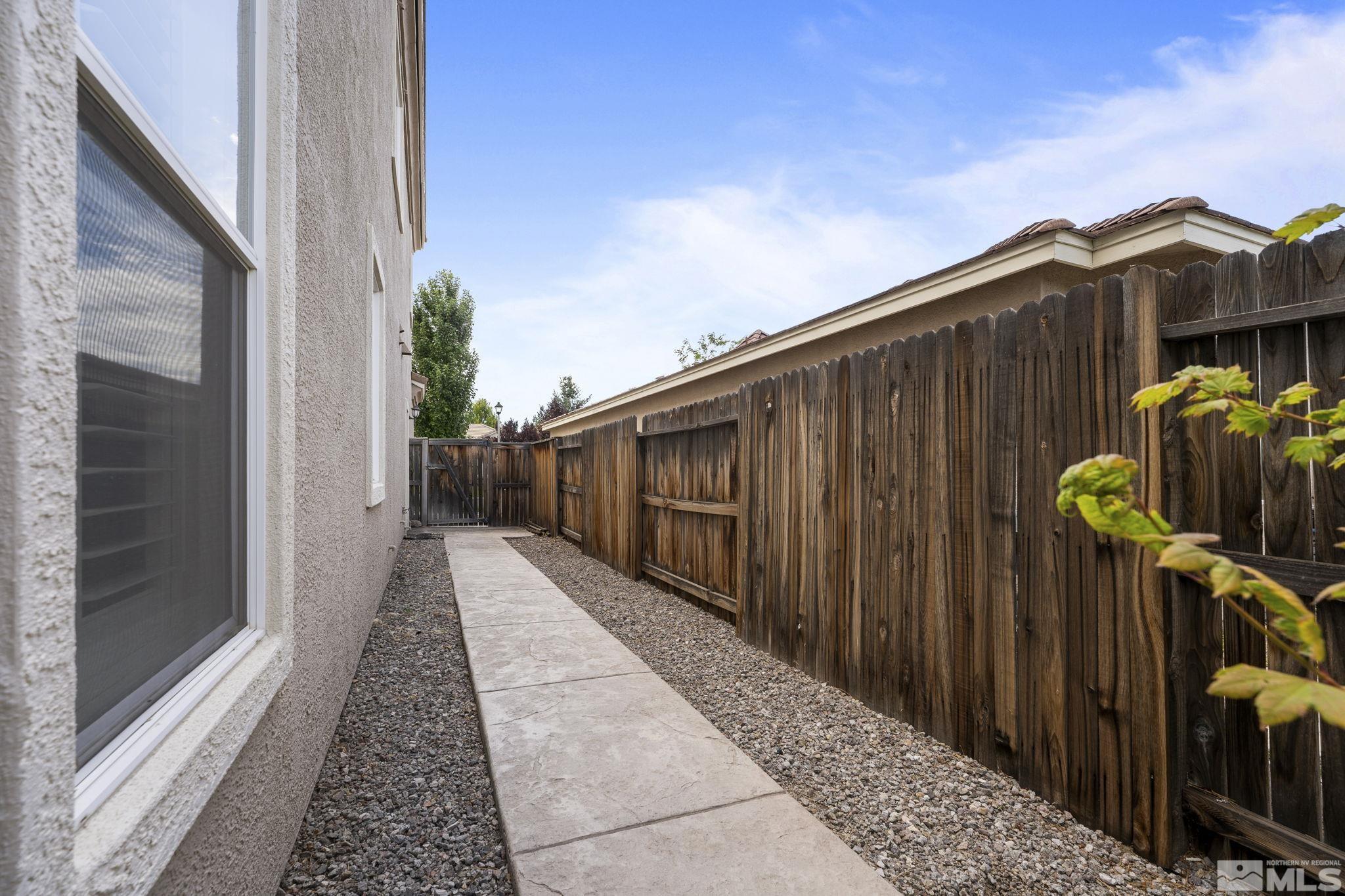 10080 Goler Wash Court Reno, NV 89521 - Photo 33 of 40 a view of a pathway of a building with wooden fence