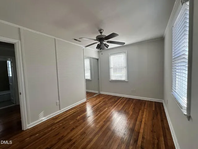 wooden floor in an empty room with a window