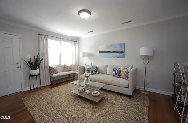 a living room with furniture and wooden floor