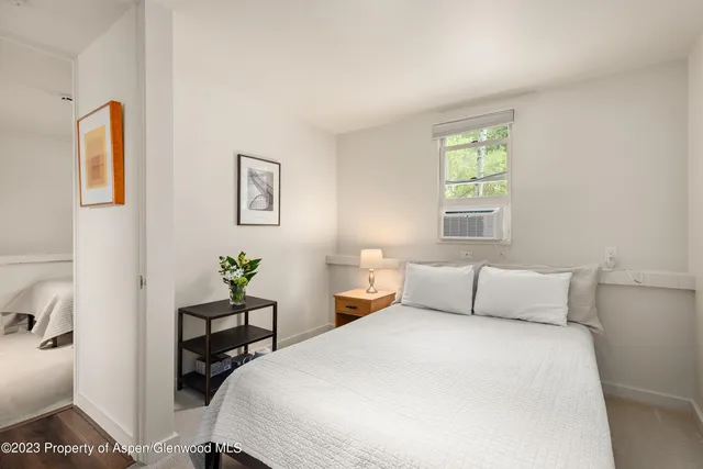 a bedroom with two beds and a window