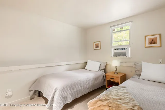 a view of a workspace with furniture and a book shelf