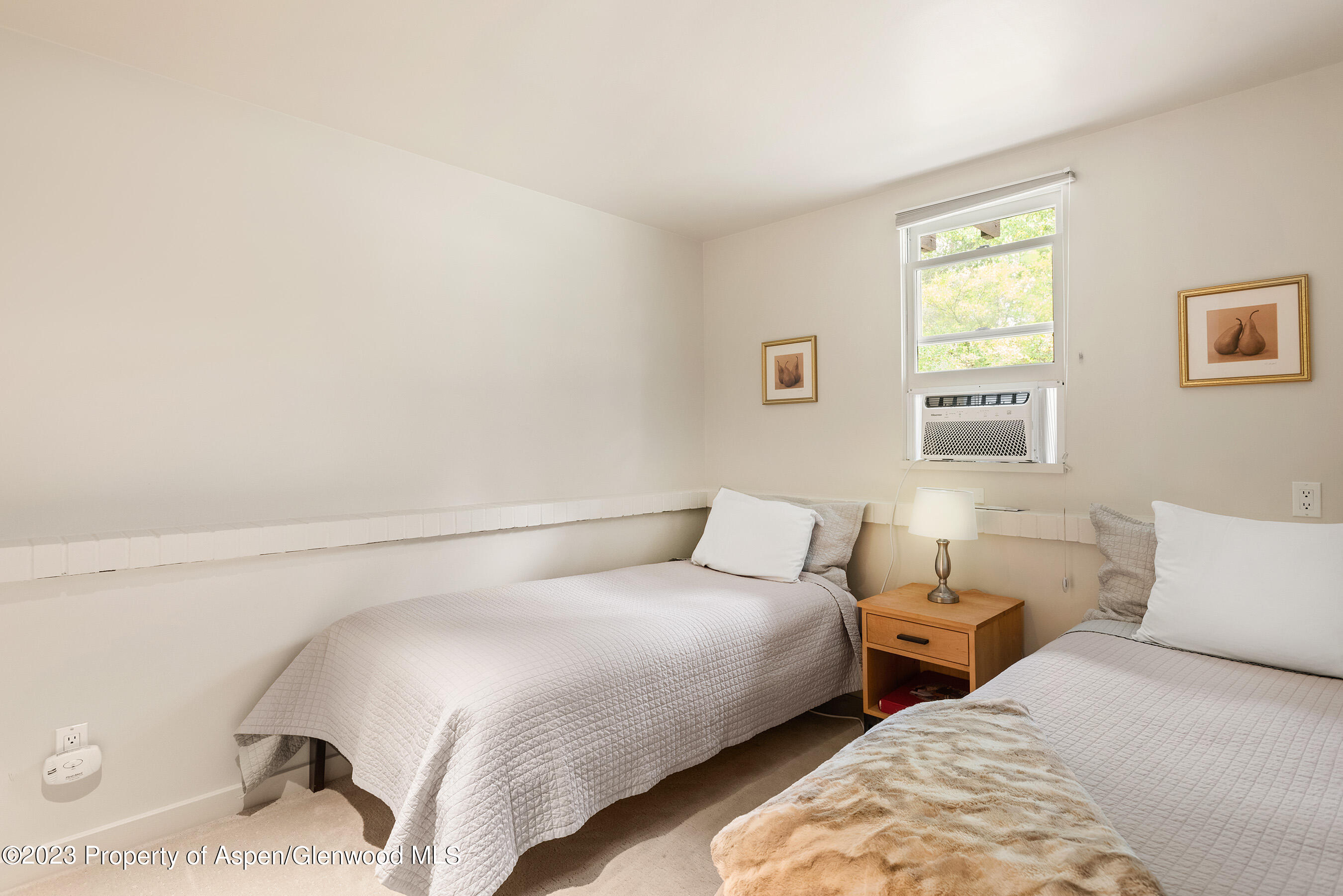 81 Meadows Trustee Road Aspen, CO 81611 - Photo 22 of 26 a bedroom with two beds and a window